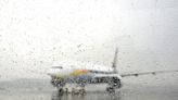 Delta is getting flak after a passenger posted a video of her seat and bag getting soaked by a torrent of rain pouring through an open plane door