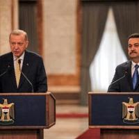 Iraq's Prime Minister Mohammed Shia al-Sudani (R) and Turkey's President Recep Tayyip Erdogan speak to reporters in Baghdad