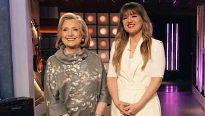 Kelly Clarkson, 41, pulls off short shorts with platform heels after 40lb weight loss from power walking as she interviews Hillary Clinton