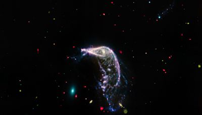 Photograph of the Penguin Galaxy chasing the Egg commemorates second space anniversary of the James Webb Space Telescope