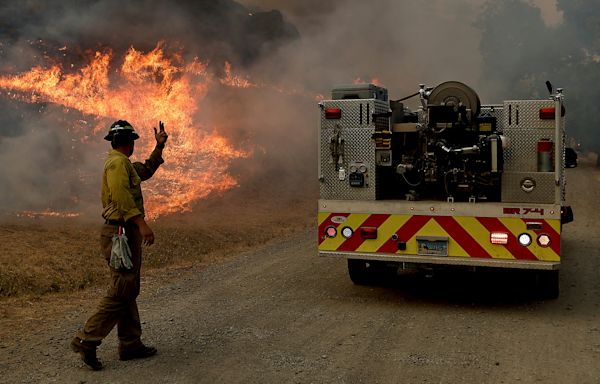 Wildfires: homes burn as flames descend on a Southern California neighborhood