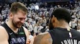 Dallas star Luka Doncic (L) celebrates with Kyrie Irving after the Mavericks' victory over the Minnesota Timberwolves in game two of the NBA Western Conference finals