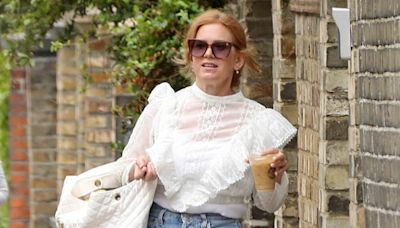 Isla Fisher looks typically chic in a sheer white blouse in Hampstead