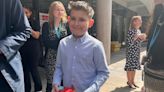 Cancer patient Ellis, 11, receives books and chocolate coin from King and Queen