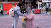 Watch as New York’s Times Square hosts weddings and proposals for Valentines Day