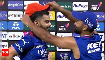 Watch: What Virat Kohli did after receiving the Orange Cap from Dinesh Karthik | Cricket News - Times of India