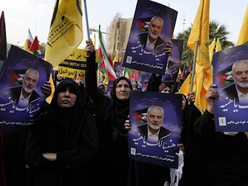 Iran’s supreme leader prays over the coffin of Hamas leader Haniyeh, whose killing risks a wider war