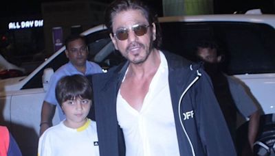 Shah Rukh Khan flashes a rare smile for paparazzi as he flies out of Mumbai with AbRam. Watch