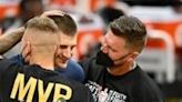 Denver Nuggets star Nikola Jokic, center, is congratulated by his brothers, one of whom is under investigation by the NBA for allegendly punching a fan after a Nuggets victory