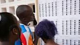 Togolese lined up at schools to look for their names on electoral lists before voting