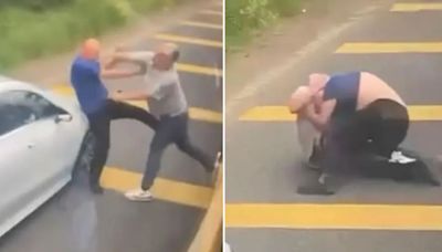 Shocking moment school bus driver trades punches with motorist in roadside brawl