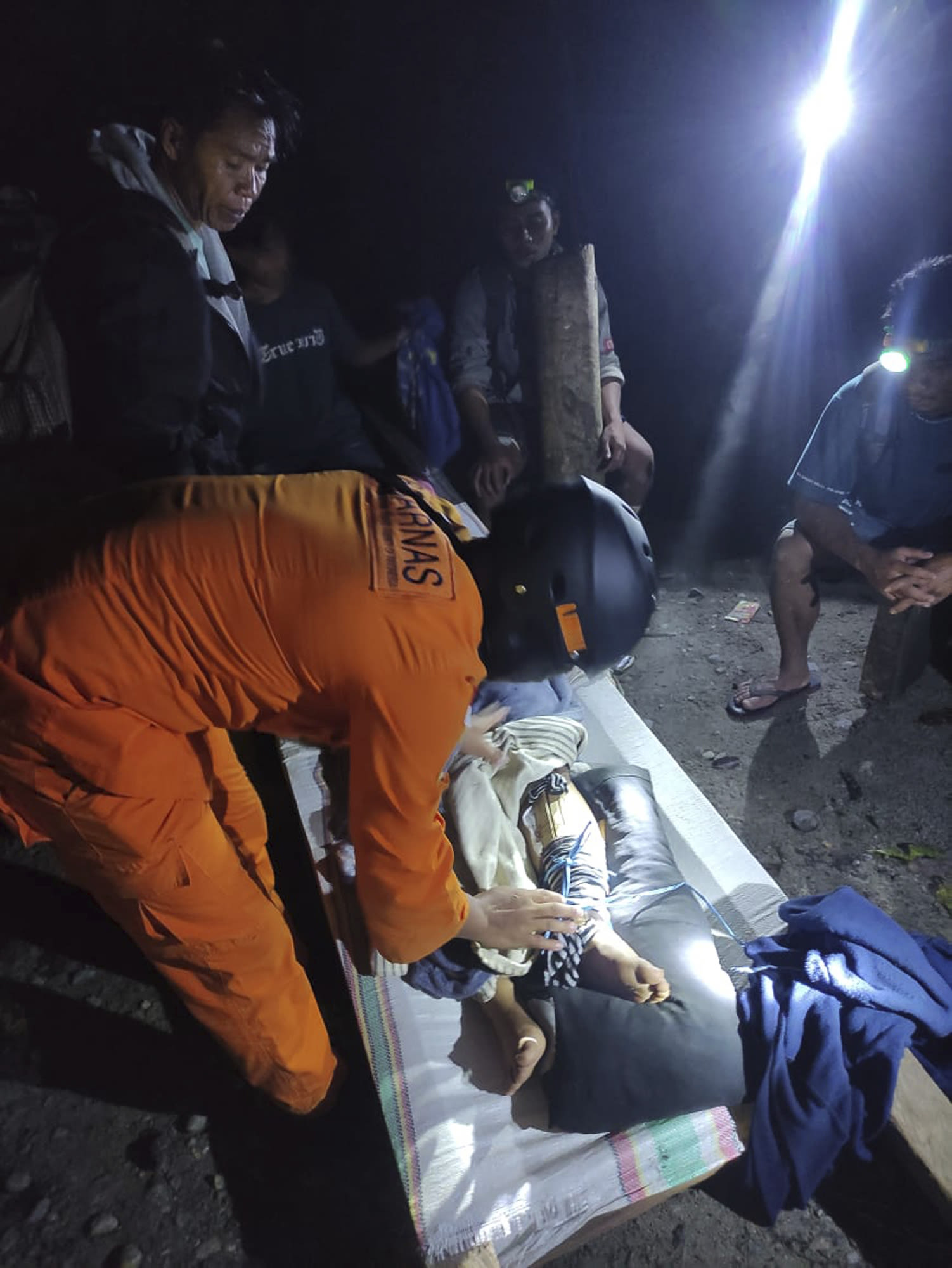 Rescuers search for dozens buried by an Indonesian landslide that killed at least 23 people
