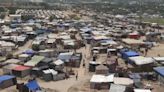 Palestinians displaced by the Israeli offensive live in tents and search for food