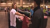 Volunteers help to fill backpacks with school supplies for local students in need