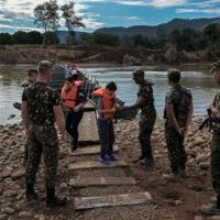 Soldiers collect life jackets from people who crossed a floating pedestrian bridge over the Forqueta River between the municipalities of Marques de Souza and Travesseiro in Rio Grande do Sul, Brazil, on...