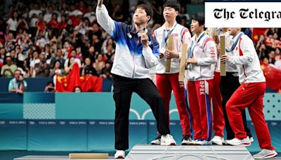 North and South Korea table tennis stars take selfie on Olympics podium in rare show of unity