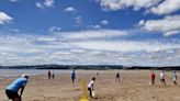 Fundraising cricket match played on the sand