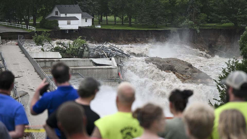 Part of a Minnesota home has plunged into the Blue Earth River as deadly Midwest flooding threatens the nearby Rapidan Dam