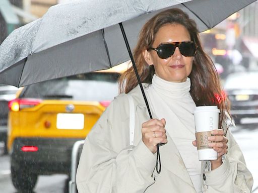 Katie Holmes nails city chic in trench coat and snakeskin boots as she arrives for her matinee performance