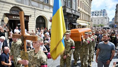 Thousands in Ukraine attend funeral of former lawmaker and critic of Russia who was killed in Lviv