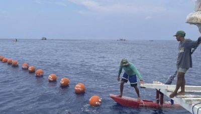 Chinese coast guard shadows Filipino activists sailing toward disputed shoal