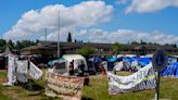 Hundreds of asylum-seekers are camped out near Seattle. There's a vacant motel next door