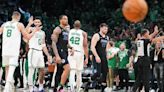 Dallas Mavericks guard Luka Doncic and forward P.J. Washington head to the bench for a time out after a basket by Boston Celtics center Kristaps Porzingis during...