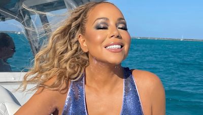 Mariah Carey sunbathes in blue sequin dress on beach while celebrating birthday