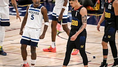 Anthony Edwards of the Minnesota Timberwolves celebrates as Michael Porter Jr. and Aaron Gordon of the Denver Nuggets walk to the bench for a timeout during the fourth quarter of the Timberwolves’ 106-80...