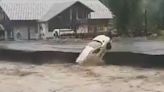 Watch as devastating floods tear through homes & spark landslide in Switzerland