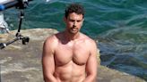 Shirtless Theo James shows off his hunky physique in white trunks