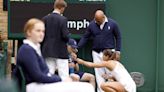 Jodie Burrage tends to unwell ball boy during first-round Wimbledon defeat