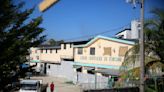 Hospital director in Haiti says police rescued women and children after gangs surround facility