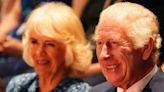 Charles and Camilla giggle as they watch play about family betrayal