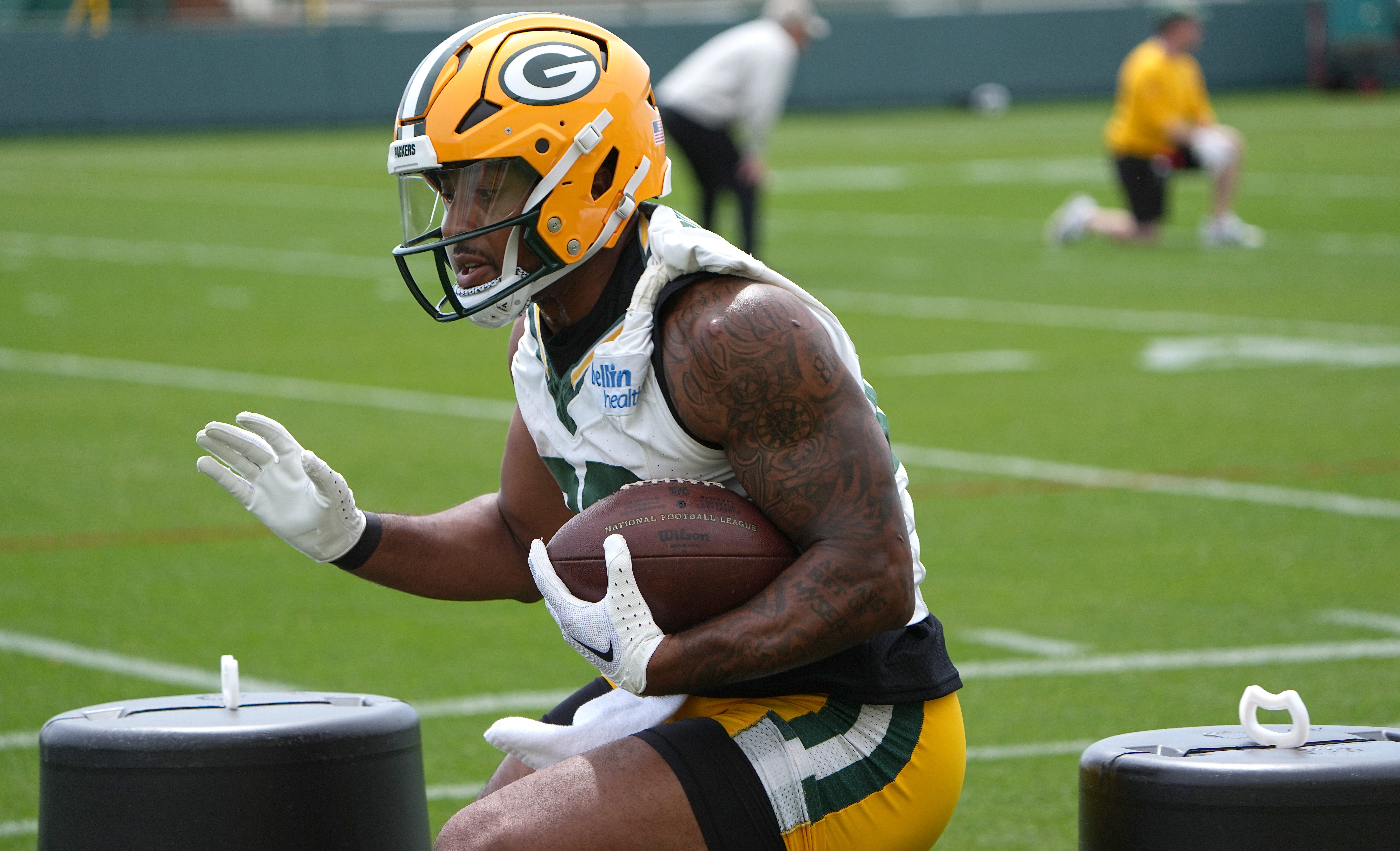 AJ Dillon runs the stairs at an empty Lambeau Field and teammate Keisean Nixon tells him to go on vacation