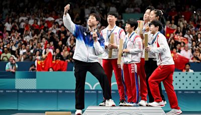 North and South Korea table tennis stars take selfie on Olympics podium in rare show of unity