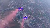 Skydivers fly through London's Tower Bridge