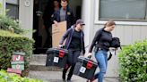 FBI agents carry boxes out of a home associated with Oakland Mayor Sheng Thao during a raid in Oakland, California, on June 20, 2024.