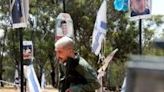 An Israeli soldier mourns at a memorial for people taken hostage or killed in Hamas's attack on the Supernova music festival on October 7, 2023, at the site of the festival near Reim, southern Israel