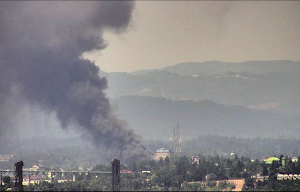 Large pile fire sends up plume of smoke over North Portland