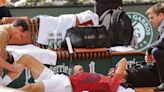 Novak Djokovic's French Open title defense and stay at No. 1 end because of an injured knee