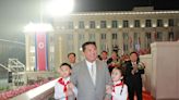 North Korea threw a military parade in the middle of the night for its 73rd birthday, and photos show a slimmed-down Kim Jong Un and marchers in hazmat suits