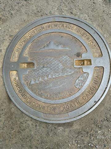 Answer Woman: Who makes the manhole covers with river, mountains and sky design? How many?