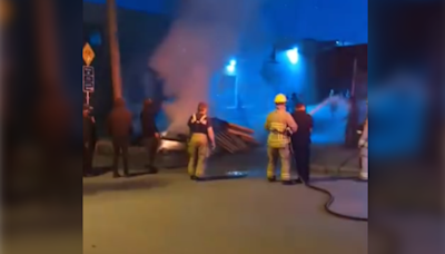 Video shows police officer taking firefighter's hose, spraying people in East Vancouver