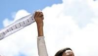 Venezuelan opposition leader Maria Corina Machado speaks to supporters while holding up electoral records during a rally in Caracas on August 28, 2024