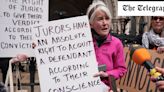 Protester who held sign aimed at jury outside climate trial escapes legal action