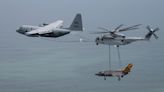 This Marine Corps helicopter refueled from a Navy tanker while carrying a Navy fighter