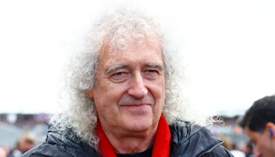 Queen's Brian May waves chequered flag at Silverstone