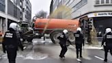 Watch: Angry farmers block streets, dump manure and clash with police in Brussels