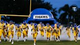 Why were people arrested in a Florida high school football recruiting scandal?